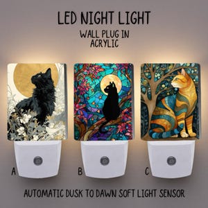 May include: Three LED night lights with cat designs. The lights are wall plug-ins made of acrylic. The designs include a black cat with a full moon, a black cat on a branch, and a striped orange cat. The lights have an automatic dusk to dawn sensor.