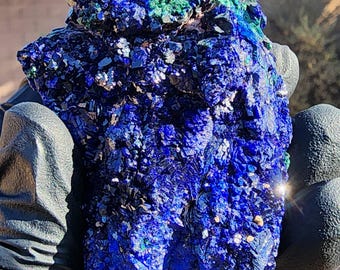 May include: A large, rough, blue and green azurite and malachite specimen. The azurite is a deep blue color and the malachite is a bright green color. The specimen is very detailed and has a lot of texture.