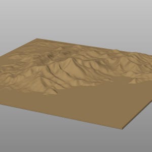May include: A 3D rendering of a tan-colored landscape with rolling hills and mountains. The terrain is set on a rectangular base, with a smooth, flat surface surrounding the textured landforms. The overall effect is a stylized representation of a natural environment.