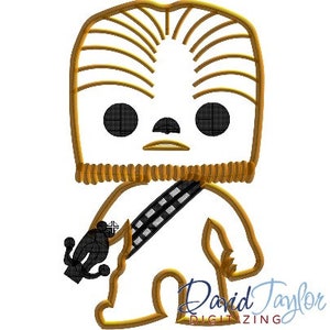 May include: A digital embroidery design featuring a stylized Chewbacca character. The design has a tan outline with black details for the eyes, nose, and bandolier. The character is holding a black weapon. The design is on a white background.