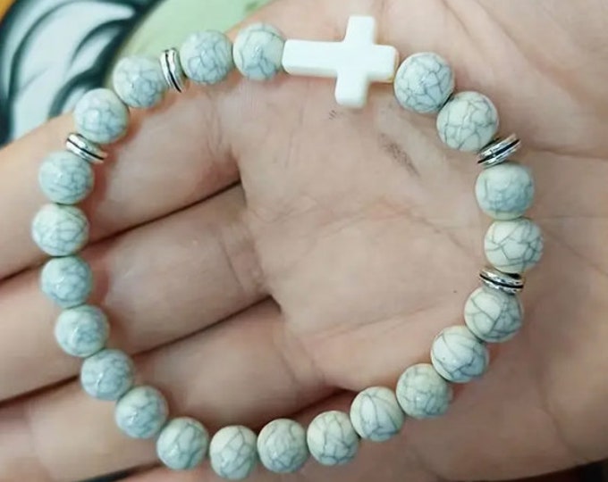 White beaded bracelet with cross