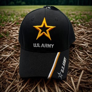 May include: Black baseball cap featuring a gold star emblem and the text "U.S. ARMY" embroidered in white. The cap has a curved brim and a design with white and gold stripes. The words "U.S. ARMY" are also printed on the side.
