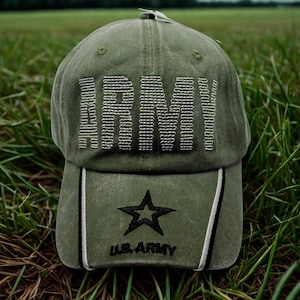 May include: Olive green baseball cap with the word "ARMY" embroidered across the front in white. Below the word "ARMY" is a black star and the words "U.S. ARMY". The cap has a curved brim and a white tag.
