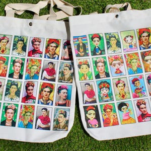 May include: Two white canvas tote bags with long handles. Each bag features a grid of colorful portraits of women, including Frida Kahlo.