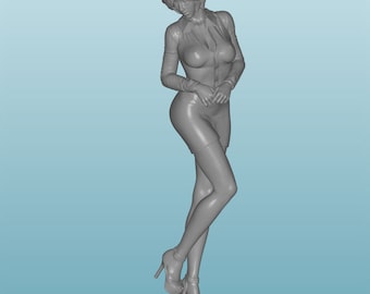 May include: A gray figurine of a woman wearing a skirt and blouse, standing on a round base. The woman is posed with her hands clasped in front of her, looking down.