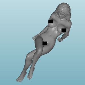 May include: A grey 3D printed figurine of a woman lying down with her hair flowing behind her.