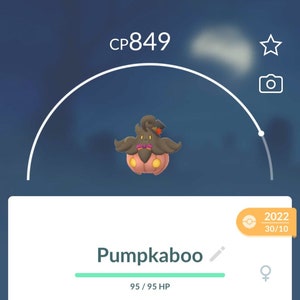 May include: A digital screenshot of a Pumpkaboo Pokemon character in a mobile game. The character is a pumpkin with a black hat and a brown face. The character is level 849 and has 95 out of 95 health points. The character is a Ghost and Grass type. The character weighs 3.96 kg and is 0.32 meters tall. The character has 2,214,871 stardust, 71 Pumpkaboo candy, and 11 Pumpkaboo XL candy. The character can be powered up with 5,000 stardust or evolved with 200 Pumpkaboo candy.