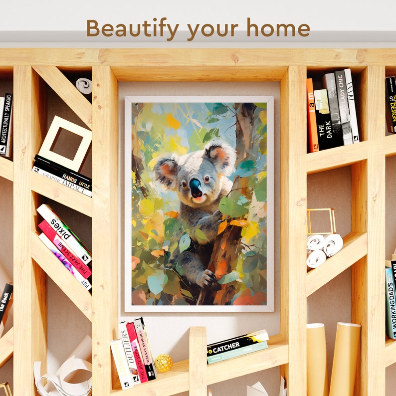May include: A framed print of a koala bear climbing a tree. The koala is grey and has large, black eyes. The tree is green and has yellow leaves. The print is in a white frame and is hanging on a wooden shelf.