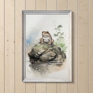 May include: Watercolor painting of a brown toad sitting on a rock in a pond. The toad is looking at the viewer with its mouth closed. The background is a soft blue and green.