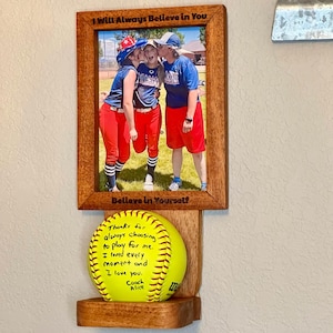 Softball and Baseball First Homerun Frame and Ball Holder. Unique way to display a special Baseball or Softball memory. Hanging Version.