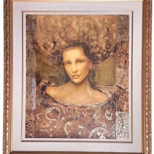 May include: A framed portrait of a woman with a serene expression, featuring a large, textured headdress. The artwork is dominated by warm, earthy tones of brown and gold, with intricate details in the clothing and background. The frame is ornate, with a gold finish.