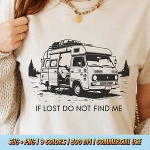 May include: Beige t-shirt featuring a black and white illustration of a camper van with the text "IF LOST DO NOT FIND ME". The graphic includes trees and a ladder. The bottom of the shirt has text that reads "SVG + PNG | 9 COLORS | 300 DPI | COMMERCIAL USE".
