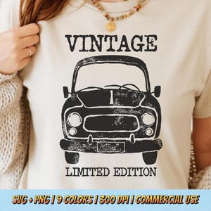May include: A cream-coloured t-shirt with a black vintage car design. The words "VINTAGE" and "LIMITED EDITION" are printed above and below the car illustration. A casual wear item.