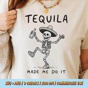 May include: A beige t-shirt featuring a black graphic of a skeleton wearing a sombrero, holding a bottle, and dancing. The text above reads TEQUILA and the text below reads MADE ME DO IT. The design is printed in a simple, bold line art style.