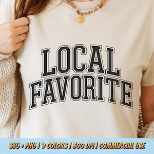 May include: A cream-colored t-shirt with the words "LOCAL FAVORITE" in bold, black, collegiate-style lettering. The shirt is being worn by a person. The bottom of the image has text that reads "SVG + PNG | 9 COLORS | 300 DPI | COMMERCIAL USE".