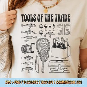 May include: Beige t-shirt with a black and white illustration of fishing tools, including lures, hooks, a reel, a net, a knife, and a tackle box. Text at the top reads "TOOLS OF THE TRADE." The tackle box has the text "GONE FISHING - BACK LATER."