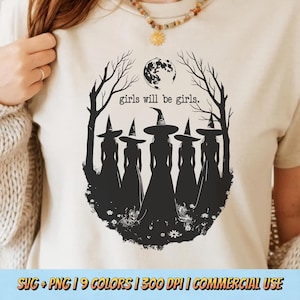 May include: Cream-coloured t-shirt with a black graphic depicting five witch silhouettes in pointed hats and dresses, set against a full moon and bare trees. The text "girls will be girls" is above the witches.