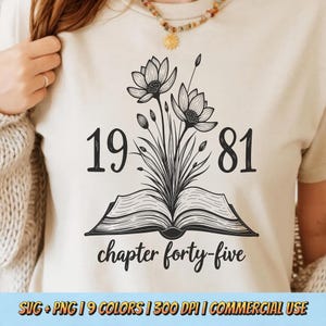 May include: Beige t-shirt with a black floral design, the numbers "1981", and the text "chapter forty-five". The design features an open book with flowers and leaves. The bottom of the shirt has the text "SVG + PNG | 9 COLORS | 300 DPI | COMMERCIAL USE".