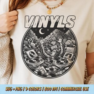 May include: Beige t-shirt with a black and white graphic of a person drowning in vinyl records, turntables, and album covers. The word "VINYLS" is printed above the graphic in a retro font.
