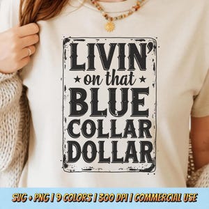 May include: A cream-colored t-shirt featuring a distressed black rectangular graphic with the words "LIVIN' on that BLUE COLLAR DOLLAR". The shirt also has text at the bottom: SVG + PNG | 9 COLORS | 300 DPI | COMMERCIAL USE.