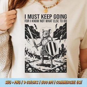 May include: Cream-colored t-shirt featuring a black and white illustration of a mouse in armor, holding a sword and shield. The text "I MUST KEEP GOING FOR I KNOW NOT WHAT ELSE TO DO" is above the illustration. The bottom of the shirt has the text "SVG + PNG | 9 COLORS | 300 DPI | COMMERCIAL USE".