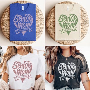 May include: Four t-shirts with the text "Senior Mom class of 2026" in various colors. The shirts are blue, beige, white, and charcoal gray. The design features a heart shape with the words "Senior Mom" and "class of 2026" in a banner.
