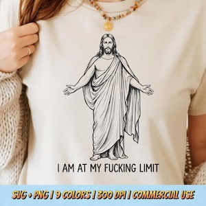 May include: A beige t-shirt featuring a black and white illustration of a figure with outstretched arms, draped in flowing robes. The text "I AM AT MY FUCKING LIMIT" is printed below the illustration. The bottom of the image includes text about the design.