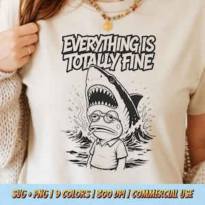 May include: Beige t-shirt with a black and white graphic of a frog wearing glasses and smoking a cigarette, with a shark above it. The text "EVERYTHING IS TOTALLY FINE" is above the shark. The bottom of the shirt has the text "SVG + PNG | 9 COLORS | 300 DPI | COMMERCIAL USE".