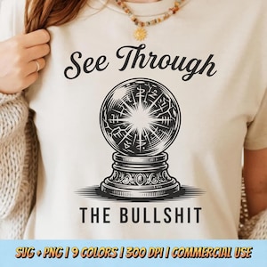 May include: Cream-coloured t-shirt featuring the text "See Through THE BULLSHIT" above a detailed black and white crystal ball illustration. The shirt also has the text "SVG + PNG | 9 COLORS | 300 DPI | COMMERCIAL USE".