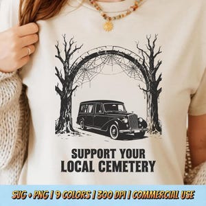 May include: Beige t-shirt featuring a black hearse driving under a spiderweb-covered archway, flanked by bare trees. The text "SUPPORT YOUR LOCAL CEMETERY" is printed below the image. The shirt design is suitable for Halloween.