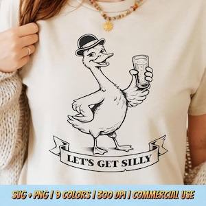 May include: A cream-colored t-shirt featuring a black and white illustration of a goose wearing a bowler hat and holding a glass of beer. A banner below reads "LET'S GET SILLY".