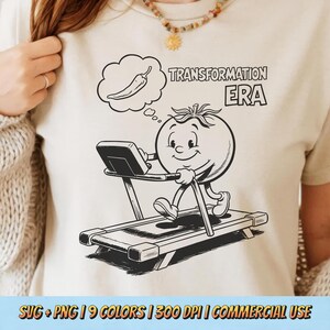 May include: A cream-colored t-shirt featuring a black and white cartoon tomato character exercising on a treadmill. The tomato is thinking of a chili pepper. The text "TRANSFORMATION ERA" is above the tomato.