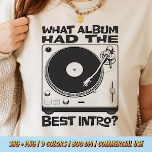 May include: Beige t-shirt featuring a black and white graphic of a turntable with the text "WHAT ALBUM HAD THE BEST INTRO?" The shirt has a crew neck and short sleeves. The design includes a record player illustration.