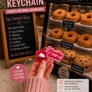 May include: A custom NFC keychain with the text "Custom Designed For You!" and "Tap. Connect. Grow." The keychain is red and features a logo. The image also shows a display case with donuts and cookies, and a chalkboard with business information.