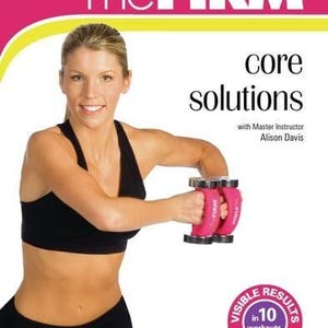 May include: A woman in black activewear holds pink dumbbells. The image features text that reads "The FIRM" and "core solutions." A circular graphic promises visible results in 10 workouts. The overall theme is fitness and exercise.