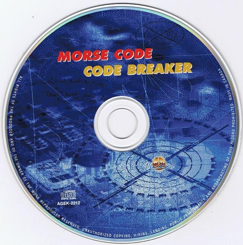 May include: A CD with a blue and silver design. The disc features the text "MORSE CODE CODE BREAKER" in red and yellow. The disc also has a white center and a silver rim.