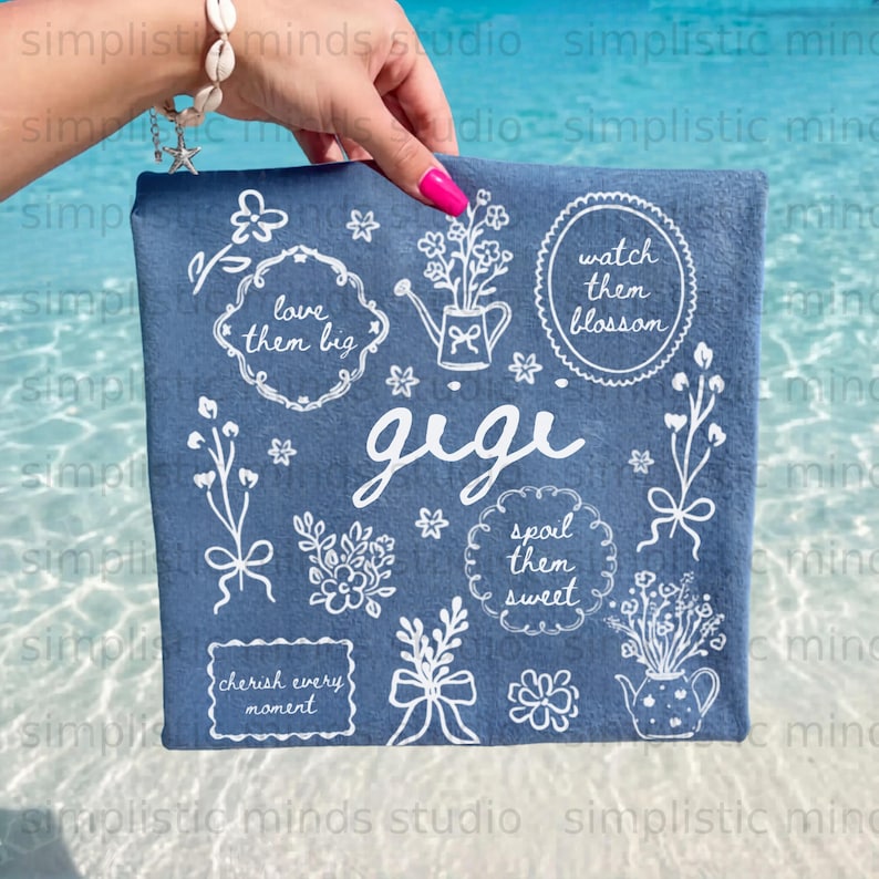 Embroidered blue towel with "Gigi" and floral designs.
