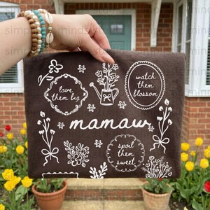 Brown fabric with "mamau" and floral designs, including "love them big," "watch them blossom," and "spoil them sweet."