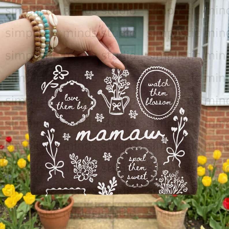 Brown fabric with "mamau" and floral designs, including "love them big," "watch them blossom," and "spoil them sweet."