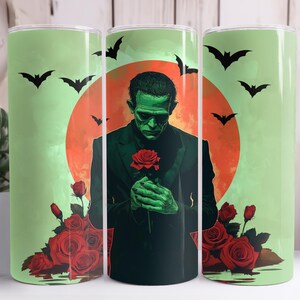 May include: A green monster holding a red rose in front of a red and orange sunset with bats flying around. The background is a light green colour.
