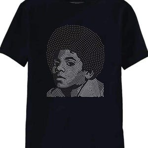 May include: Black t-shirt featuring a portrait of a person with an afro, created with a dot pattern. The portrait is in shades of white and gray, contrasting against the dark background of the shirt.