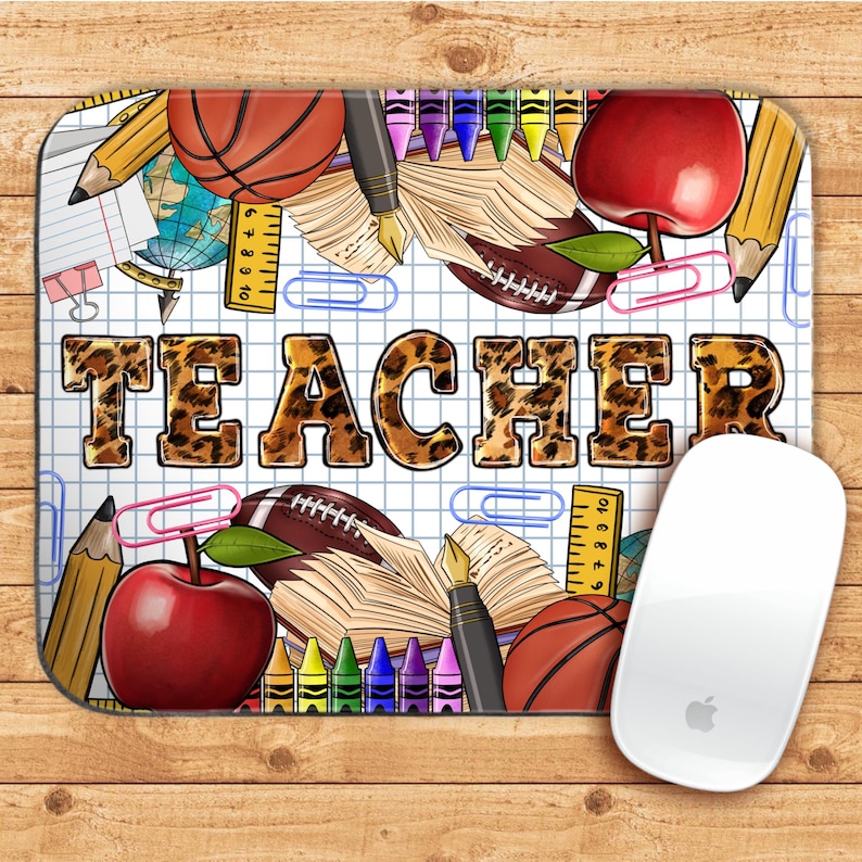 May include: A white mouse pad with a grid pattern and a leopard print word "TEACHER" in the center. The background is filled with school supplies like pencils, crayons, apples, a basketball, a football, and a ruler.