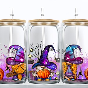 May include: Three glass tumblers with lids and straws, featuring a Halloween gnome design. Each tumbler has a different gnome with a purple and blue hat, holding a pumpkin or a potion bottle. The background is a sparkly purple and pink with spiderwebs and stars.