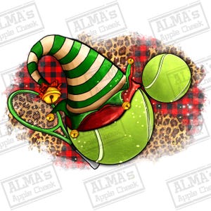 May include: A festive design featuring a tennis ball wearing an elf hat with green and white stripes, a red collar, and gold bells. A tennis racket and a second tennis ball are also present. The background has a leopard print and red plaid pattern.