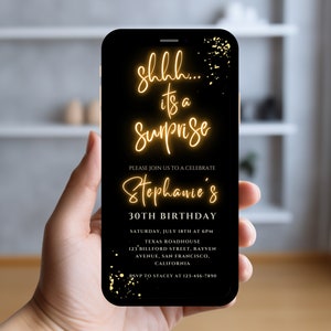 May include: A black smartphone screen displays a birthday party invitation with gold text that reads "shhh... it's a surprise Stephanie's 30th Birthday". The invitation includes the date, time, location, and RSVP information.