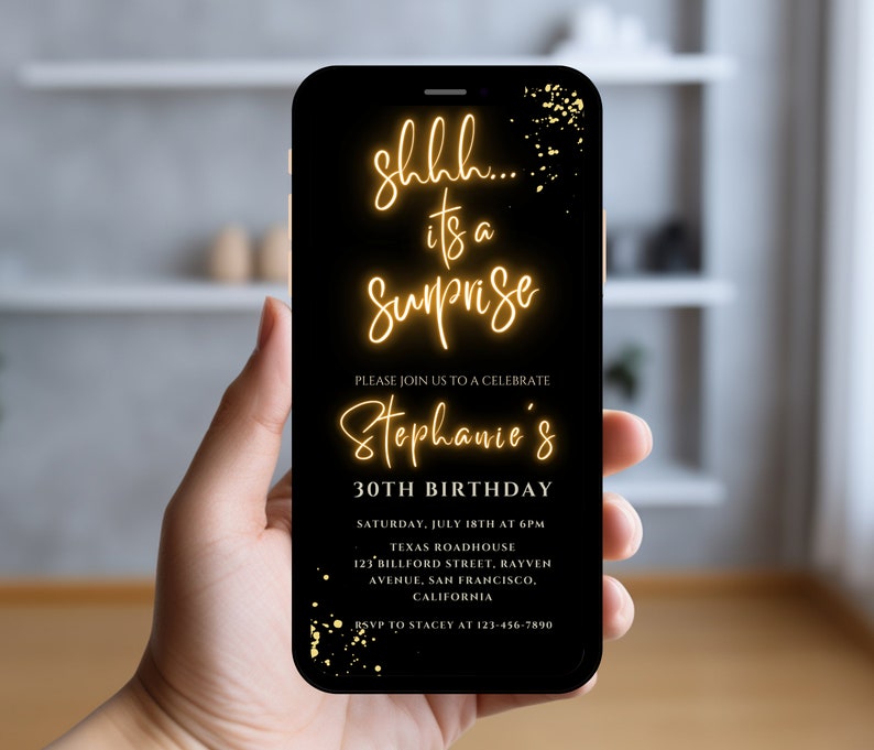 May include: A black smartphone screen displays a birthday party invitation with gold text that reads "shhh... it's a surprise Stephanie's 30th Birthday". The invitation includes the date, time, location, and RSVP information.