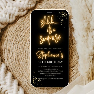 May include: A black and gold digital phone screen with a birthday party invitation. The text reads "Shh... it's a Surprise, Please join us to celebrate Stephanie's 30th Birthday, Saturday, July 18th at 6pm, Texas Roadhouse, 123 Billford Street, Rayven Avenue, San Francisco, California, RSVP to Stacey at 123-456-7890".