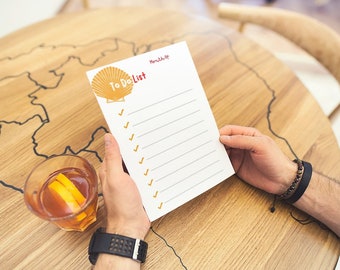 Puede incluir: Una lista de tareas blancas con un gráfico de concha y el texto "To Do List" en rojo y amarillo. La lista tiene marcas de verificación junto a cada línea.