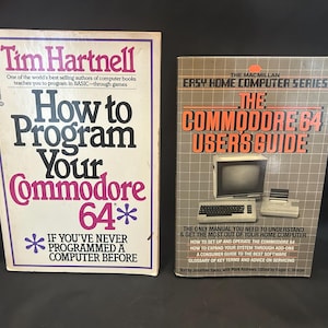 May include: Two vintage computer books for the Commodore 64. The left book is titled How to Program Your Commodore 64 by Tim Hartnell. The right book is The Commodore 64 User's Guide from The Macmillan Easy Home Computer Series, featuring a computer illustration.