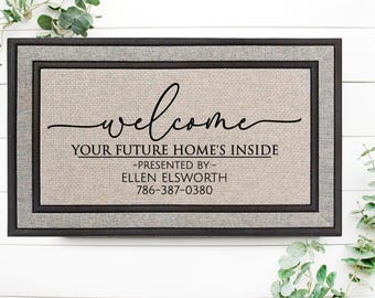 May include: A welcome mat with the text "Welcome, Your Future Home's Inside - Presented By - Ellen Ellsworth 786-387-0380". The mat is brown with a black border.